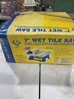 Box front and top of the 7 inch wet tile saw showing product features and image.