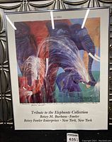 Framed art print featuring colorful elephants with title and artist information below the image.