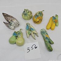 Overview of all seven porcelain figurines with a label showing lot number 356.