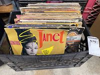 Front view of crate showing multiple vinyl records including Janet Jackson 'Control' album cover.