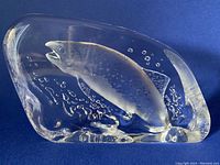 Front and side views of the clear crystal fish sculpture showing detailed etching and bubbles.