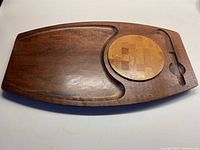 Full view of the Baribocraft cheeseboard showing the main board with curved indentations and the removable round cheese cutting board in place.