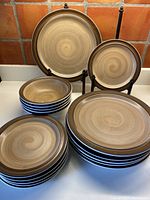 Full set arranged on counter including 6 dinner plates, 6 side plates, and 5 cereal bowls showing size differences and pattern.
