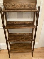 Full front view showing four-tier folding oak bookshelf