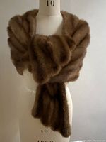 Front view of the vintage pure mink stole, showing rich chocolate and cinnamon horizontal stripes wrapped on a mannequin.