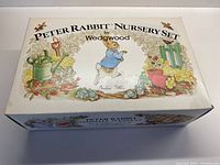 Original packaging box showing 'Peter Rabbit Nursery Set by Wedgwood' with vintage styled artwork of Peter Rabbit and garden tools.