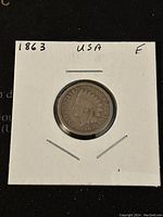 Obverse side of 1863 US Indian Head Penny showing Liberty in Native American headdress and date.