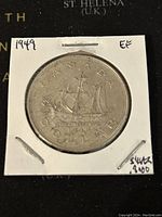 Reverse image of the 1949 Canadian Silver 1 Dollar Coin showing a sailing ship design with 'CANADA DOLLAR' inscription.