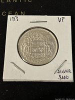Reverse side of the 1953 Canadian silver 50 cent coin showing the Canadian crowned coat of arms.