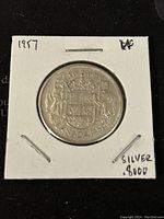 Reverse side showing Canadian coat of arms and silver purity marking.