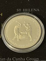 Obverse showing two blacksmiths at an anvil with Canadian and commemorative inscriptions.