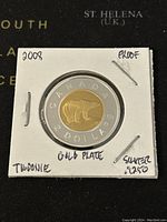 Close-up of reverse side showing the polar bear, with handwritten notes indicating gold plated center, silver .925 outer ring, proof condition, and denomination as Twoonie.