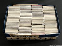 Top-down view of a box filled with over 1500 thick NHL trading cards tightly packed, mostly visible from their backs.