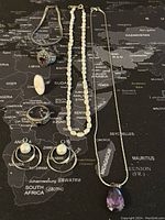 Full view of all jewelry pieces arranged on map background