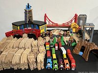 Overall view showing bundled tracks, engines, freight cars, buildings, figures and tunnels