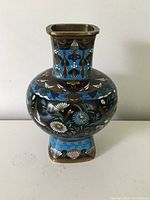 Front and side view of the vase showing detailed cloisonne bird and flower decorations and blue floral backgrounds