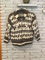 Front view of sweater showing full pattern, zipper and pockets