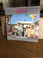 Front of the AC/DC Dirty Deeds Done Dirt Cheap LP cover showing original album artwork with censored faces.