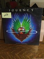 Front cover of Journey 'Evolution' LP showing colorful winged emblem artwork
