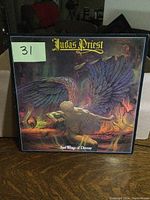 Front cover of Judas Priest Sad Wings of Destiny LP with artwork of angel figure with wings.