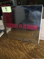 Front of the KISS Double Platinum album cover showing reflective silver surface with red text.