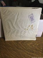 Original brown paper envelope for the vinyl album, showing printed track listings and stamp marks.