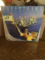 Front cover of Supertramp Breakfast in America album showing waitress and breakfast cityscape artwork with lot number sticker.