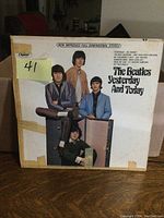 Front cover of The Beatles Yesterday And Today album showing taped and worn vintage LP album cover with The Beatles posing.