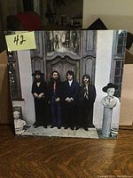 Front cover showing The Beatles standing in front of large doors.