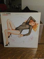 Front cover of The Cars Candy-O LP showing the stylized illustration of a woman on a white car.