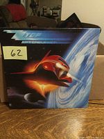 Front cover of ZZ Top Afterburner LP album featuring spaceship and Earth in space theme.