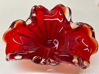 Top-down view of the bowl showing the red color with clear and amber edges and a fluted shape.