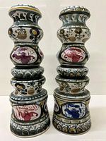 Pair of tall, hand-painted ceramic vases with colorful detailed floral and abstract designs, showing overall shape and decoration.