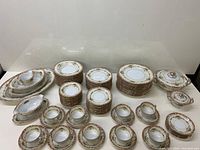 Full set arranged showing platters, stacks of plates and bowls, cups, saucers and serving pieces