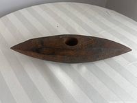 Shows full top view of the steel rock chipper head resting on a white striped fabric surface.