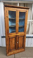 Full front view of pine corner cupboard