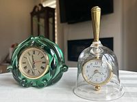 Front view of green glass Fenton clock and clear glass bell with pocket watch clock