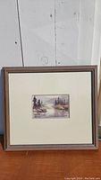 Framed artwork showing its front with lake and mountain watercolour painting inside.