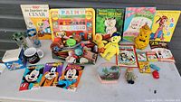 Full lot overview showing books, plush toys, various small toys, and activity books.