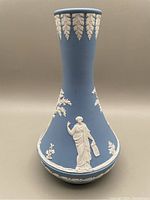 Front view of bud vase showing classical figure in white relief against blue jasperware.