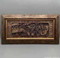 Frontal image showing entire framed Chinese carved wooden wall panel with gold gilding.