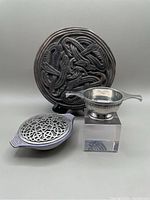 Overview photo showing all three items: stone cast plaque, pewter quaich on acrylic stand, and Uig Pottery pot pourri bowl with Celtic knot metal lid.