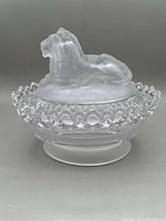 Image of the frosted lion lidded candy dish showing the lion figure on top and decorative openwork edge on the clear glass base.