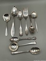 Overview of nine sterling pieces on grey background
