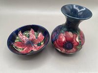 Set showing the Moorcroft cobalt blue Tigerlily trinket dish next to the signed Anemone vase with floral designs.