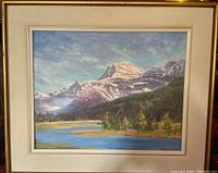 Framed original oil painting showing full landscape of mountains, forest, and water under a partly cloudy sky.