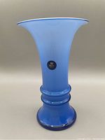 Front view of the blue Royal Copenhagen crystal vase showing the gradient blue color and dual rings around the neck.