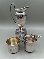 Three-piece overview: miniature pitcher, child’s cup, cream jug