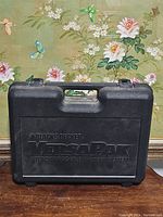 Closed black hard plastic case with raised Black & Decker VersaPak branding on the outside.