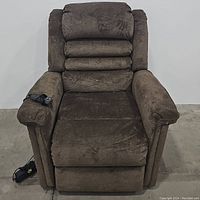 Front view of brown upholstered power lifter recliner chair with visible armrests and seat cushion.
